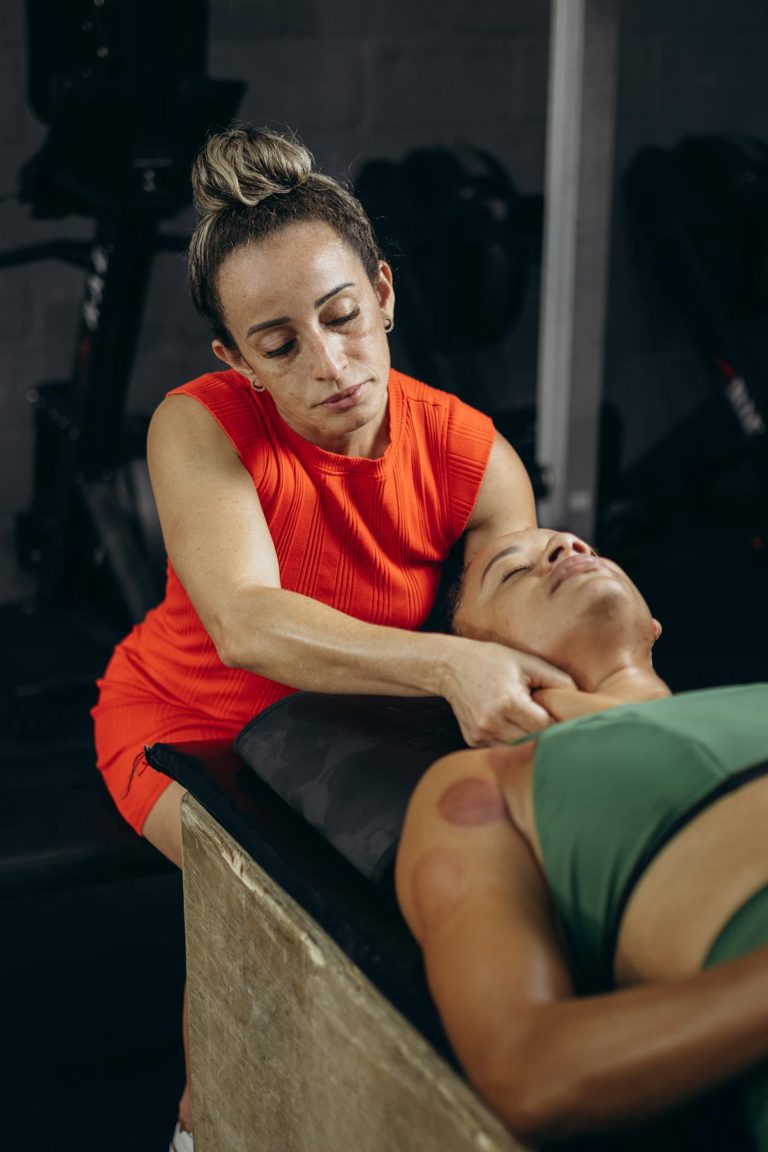 A therapist performing myofascial release on a reclining woman to improve flexibility and mobility.